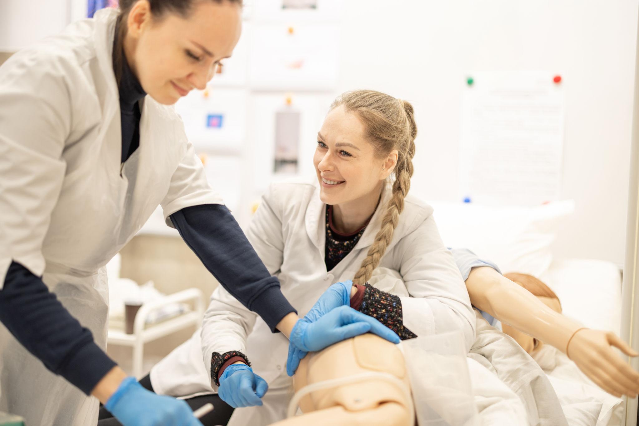 Wisconsin nursing students training with a medical mannequin