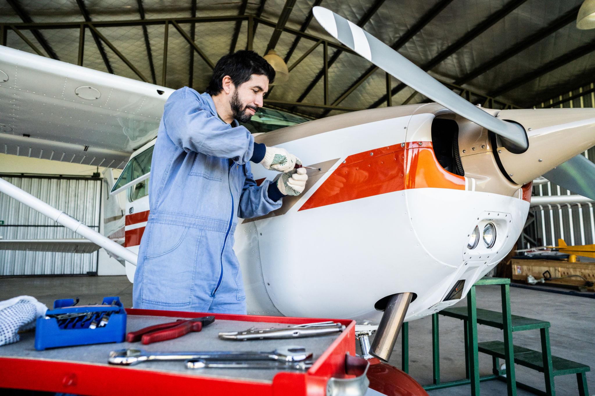 Aviation technician performing precision maintenance and inspection work