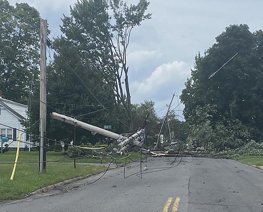 Downed utility pole after storm damage