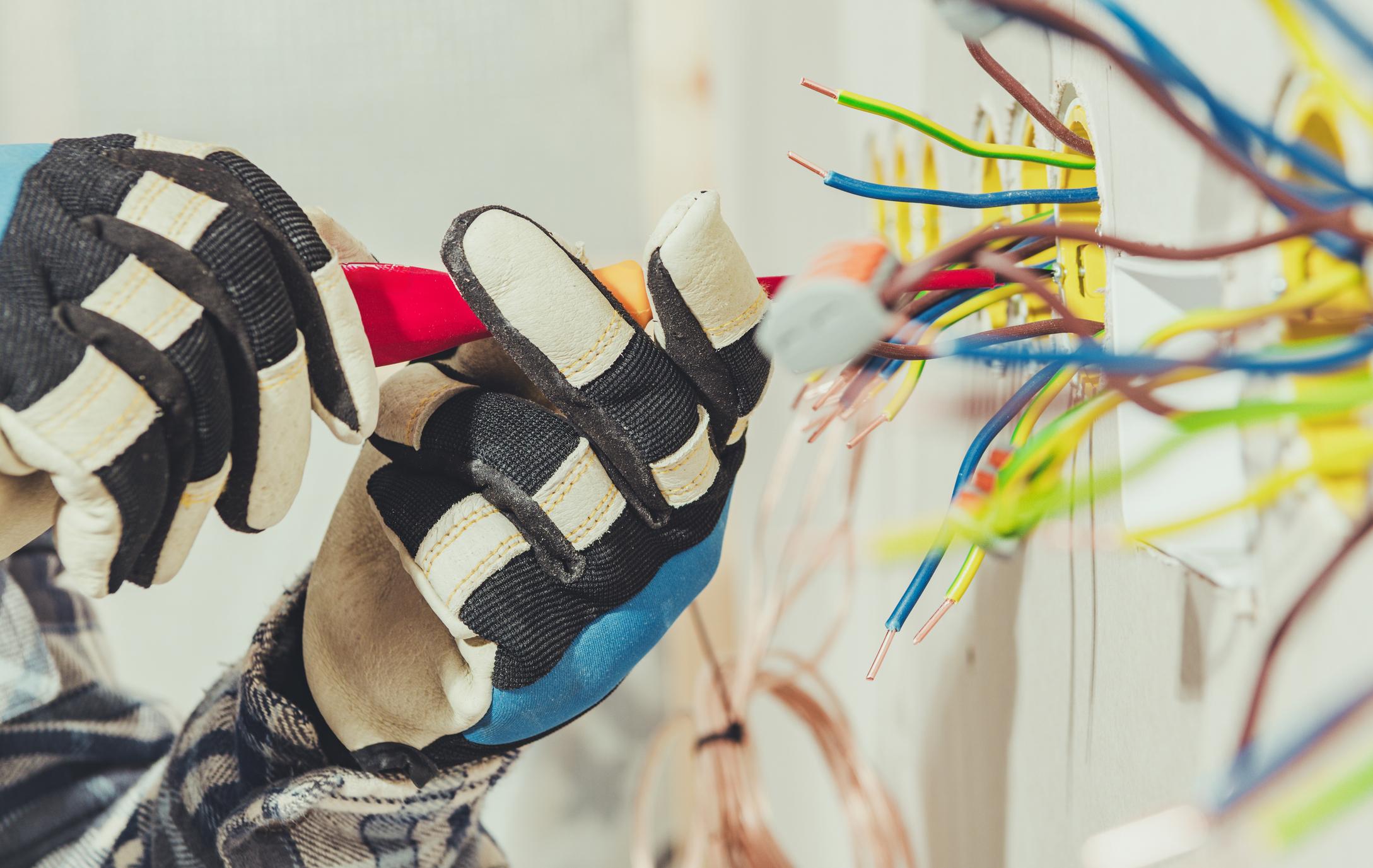 Electrician working on electrical equipment