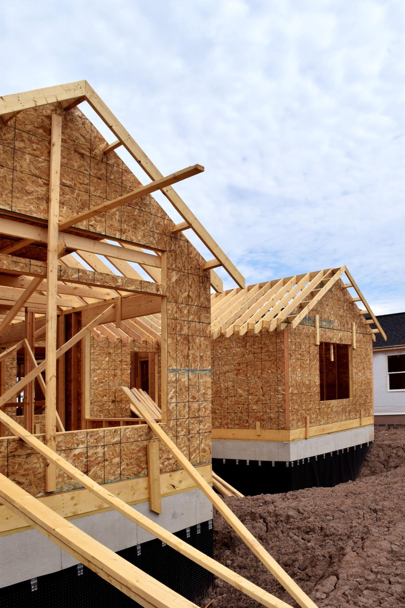 Young carpenter framing a house and learning a skilled trade