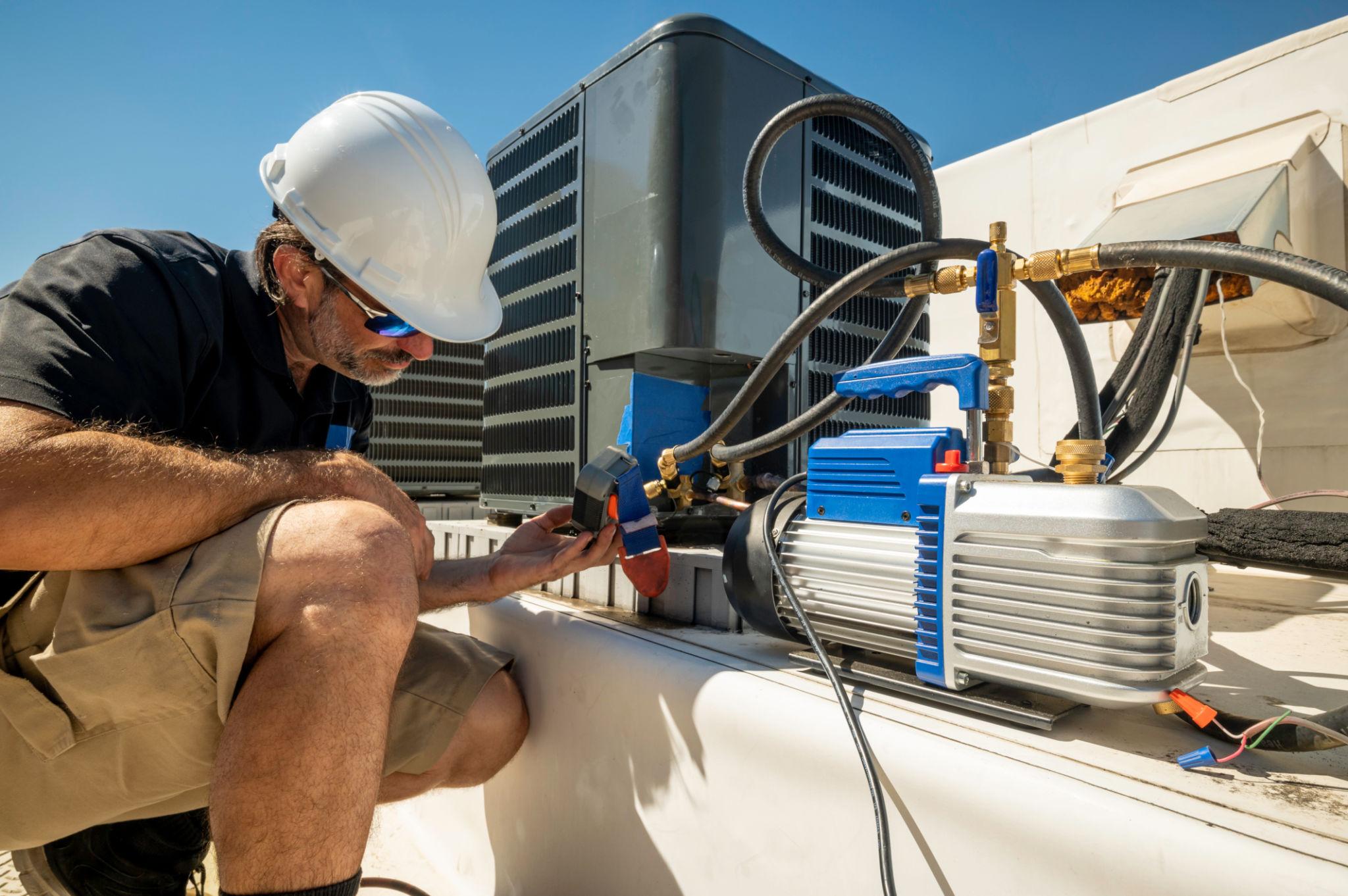 HVAC technician servicing an air conditioning system