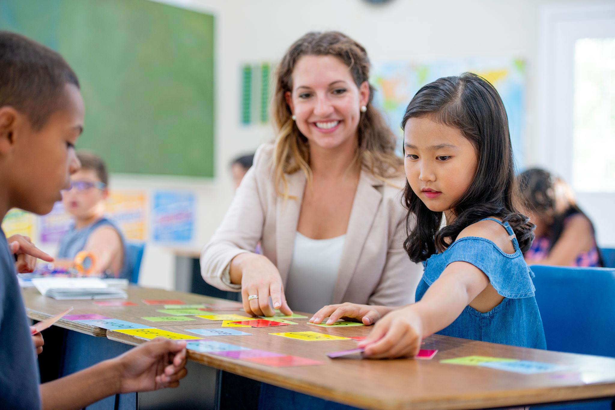 Teacher mentoring students in a classroom environment